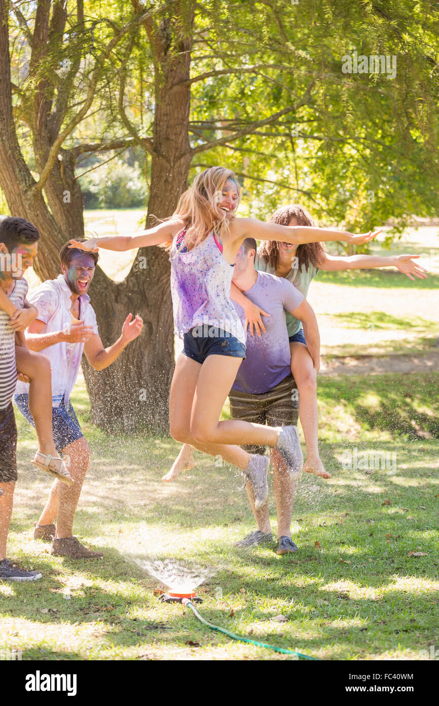 Young friends having fun with hose in the park Stock Photo - Alamy