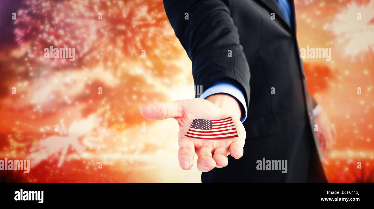 Composite image of businessman holding out his hands to the camera Stock Photo