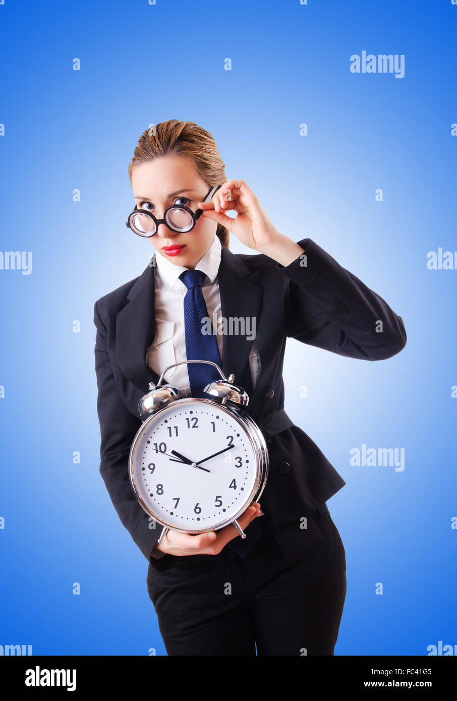 Nerd businesswoman with giant alarm clock Stock Photo - Alamy