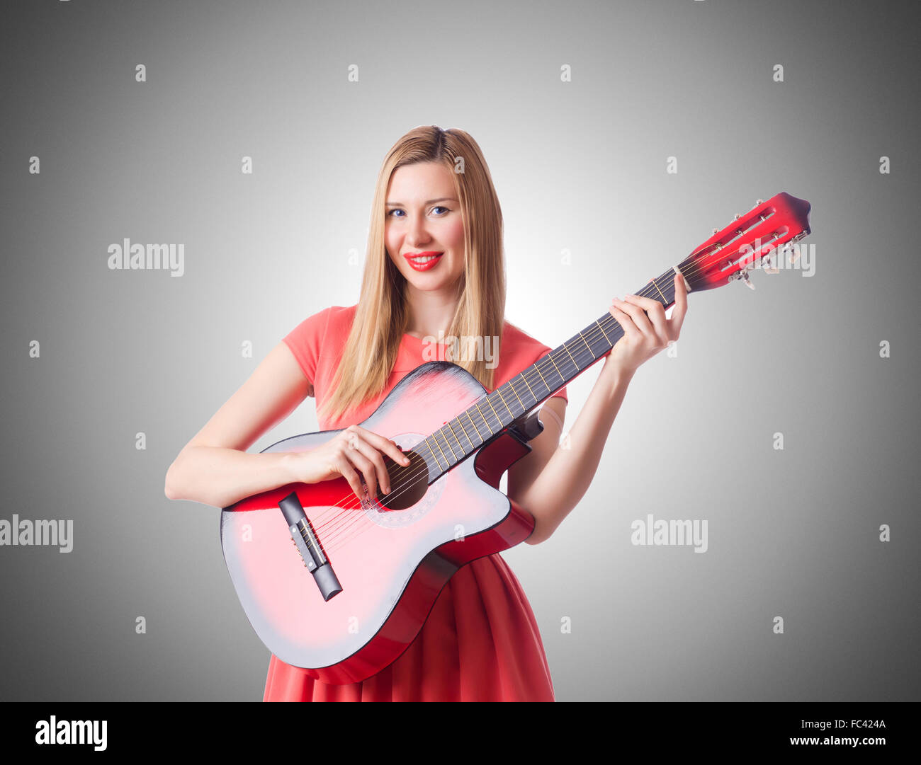 Woman playing guitar against the gradient Stock Photo - Alamy