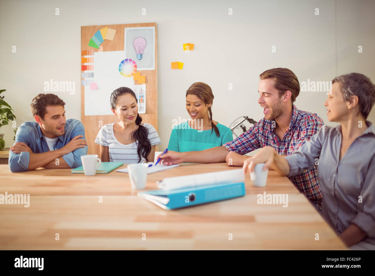Seated creative business team working together Stock Photo - Alamy