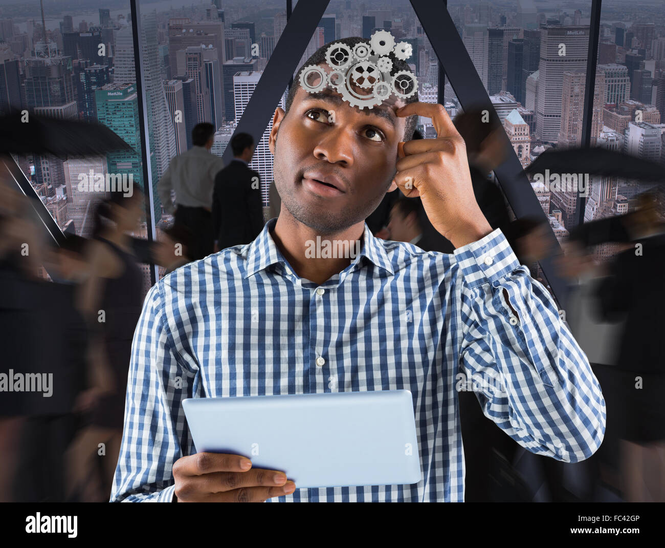 Composite image of young businessman thinking and holding tablet Stock Photo