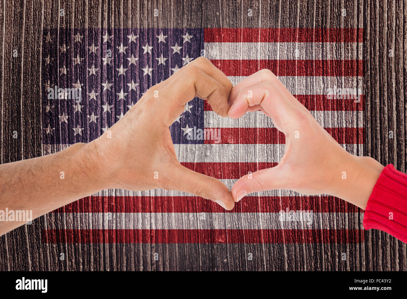 Composite image of couple making heart shape with hands Stock Photo - Alamy