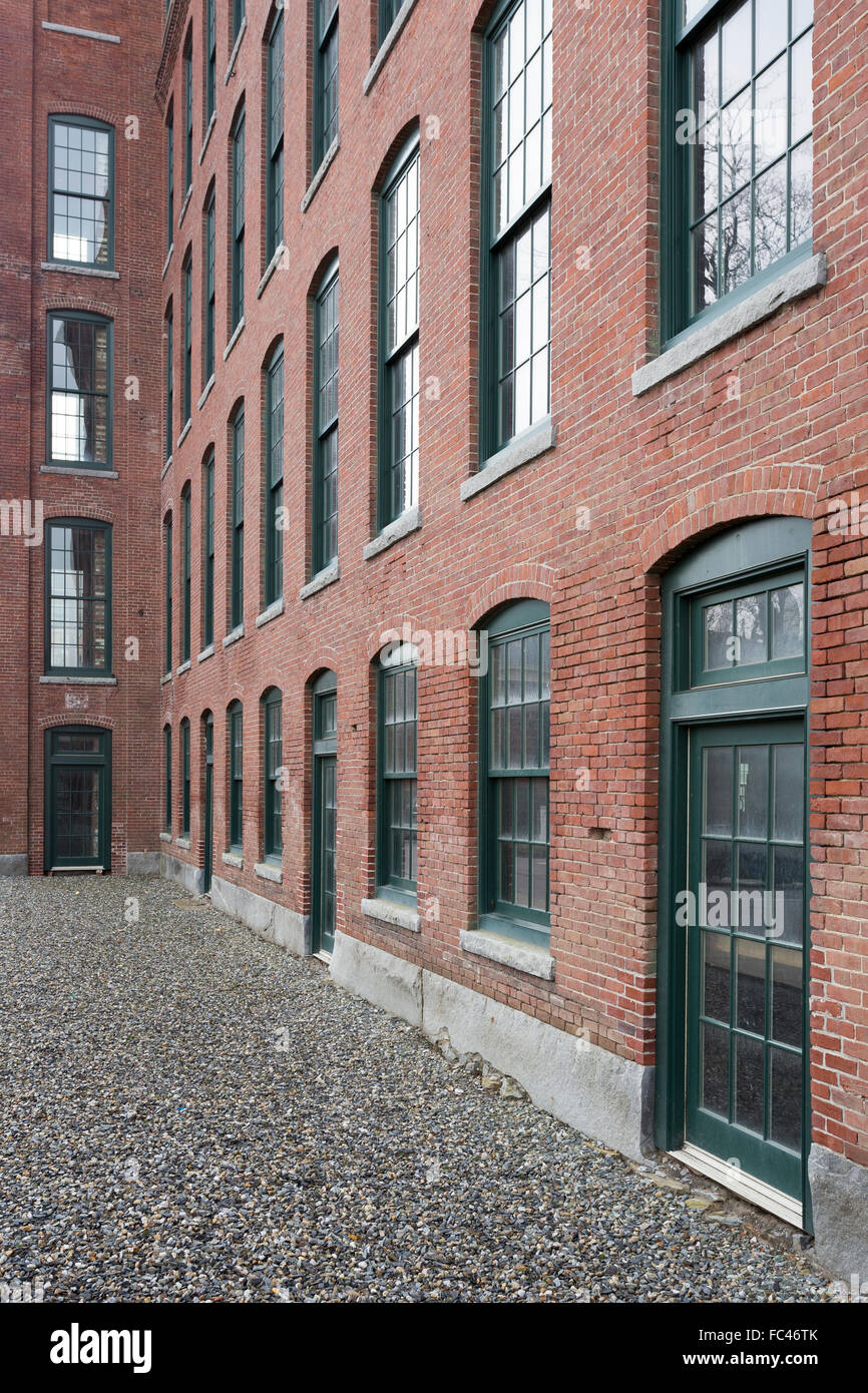 Looking down an alley along an old brick building. Stock Photo