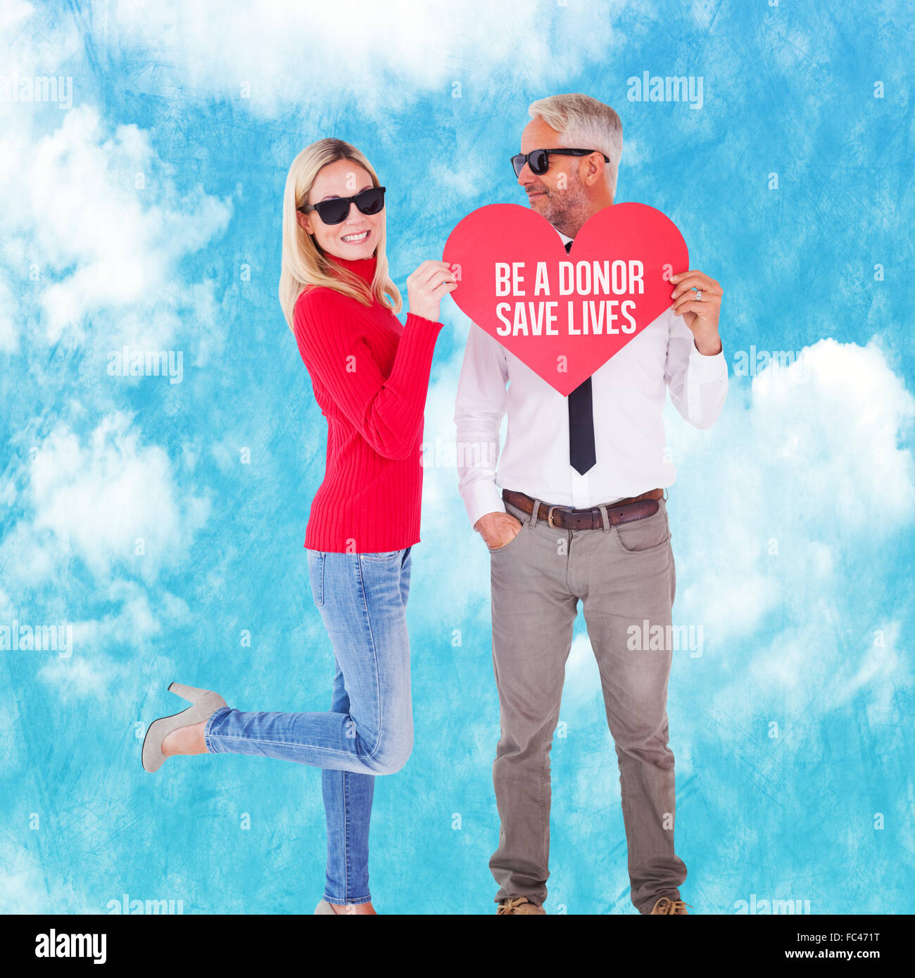 Composite image of cool couple holding a red heart together Stock Photo ...