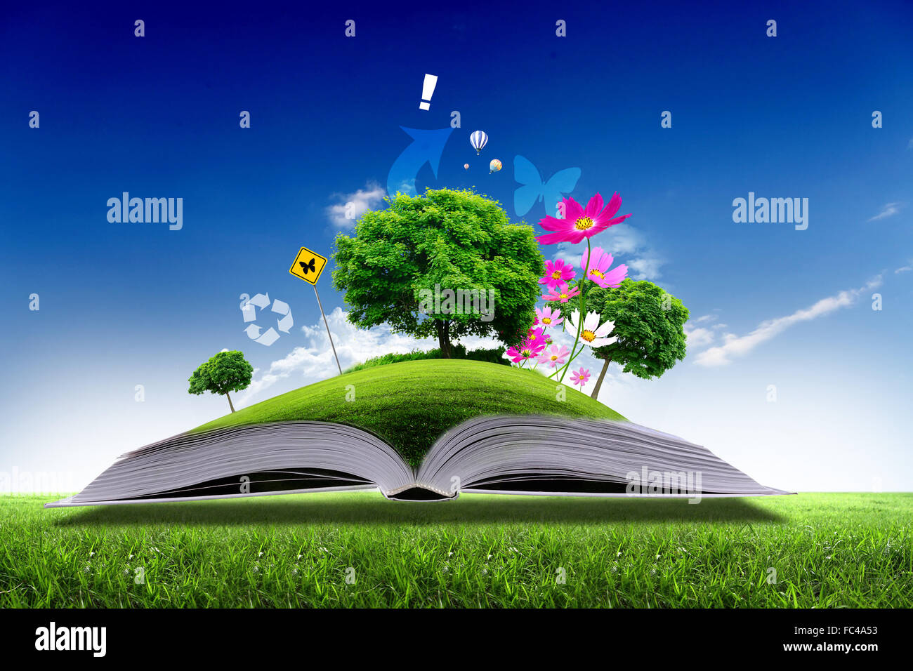 Open book with green nature world coming out of its pages Stock Photo -  Alamy