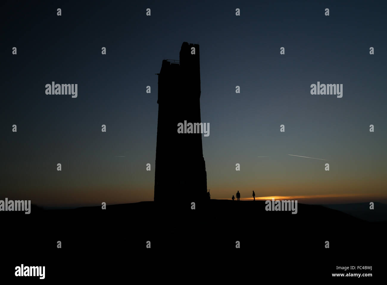 Huddersfield, West Yorks, UK. 20th January, 2016. People watch the sun set over Huddersfield in West Yorkshire, UK, next to the Victoria Tower atop Castle Hill. The UK saw temperatures plummet to below -12 degrees for the second day in a row despite the bright sunny weather across much of the country. Credit:  Ian Hinchliffe/Alamy Live News Stock Photo