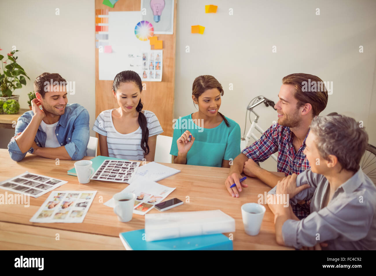 Seated creative business team working together Stock Photo - Alamy