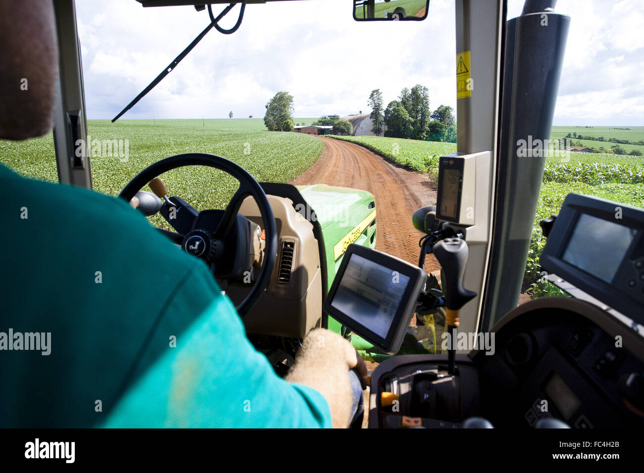 Cabin Tractor with high technology embedded in soybean plantation Stock Photo