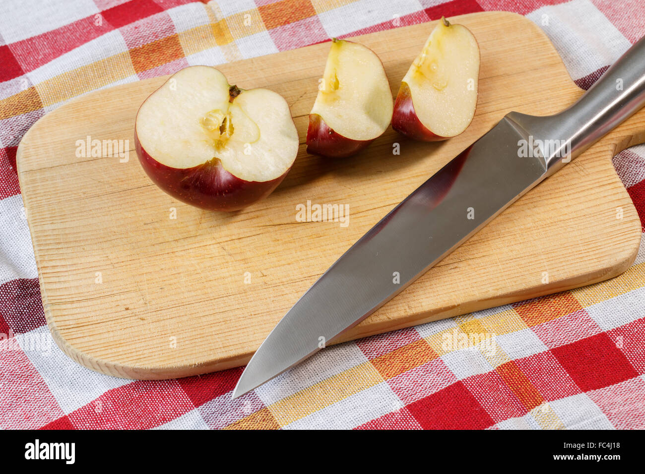 Red apple on cutting board with knife Stock Photo