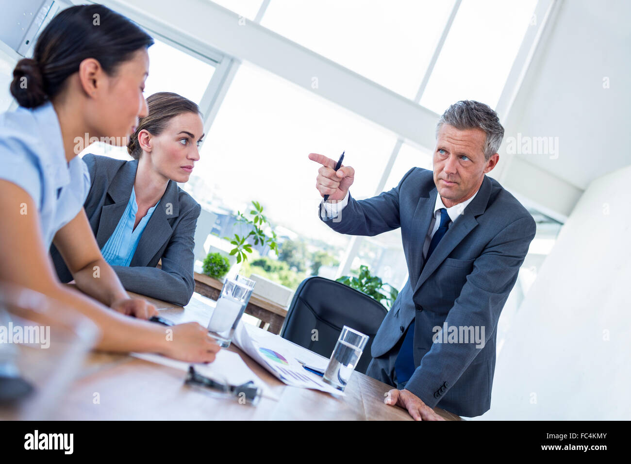 Businessman pointing his colleagues during meeting Stock Photo