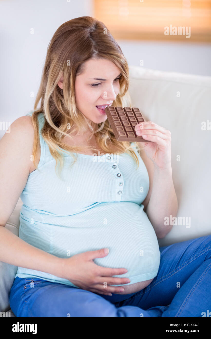 Pretty pregnant woman eating big bar of chocolate Stock Photo Alamy