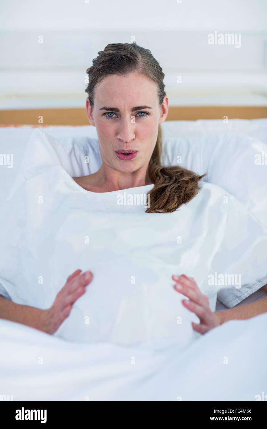 Portrait of pregnant woman suffering from pain Stock Photo
