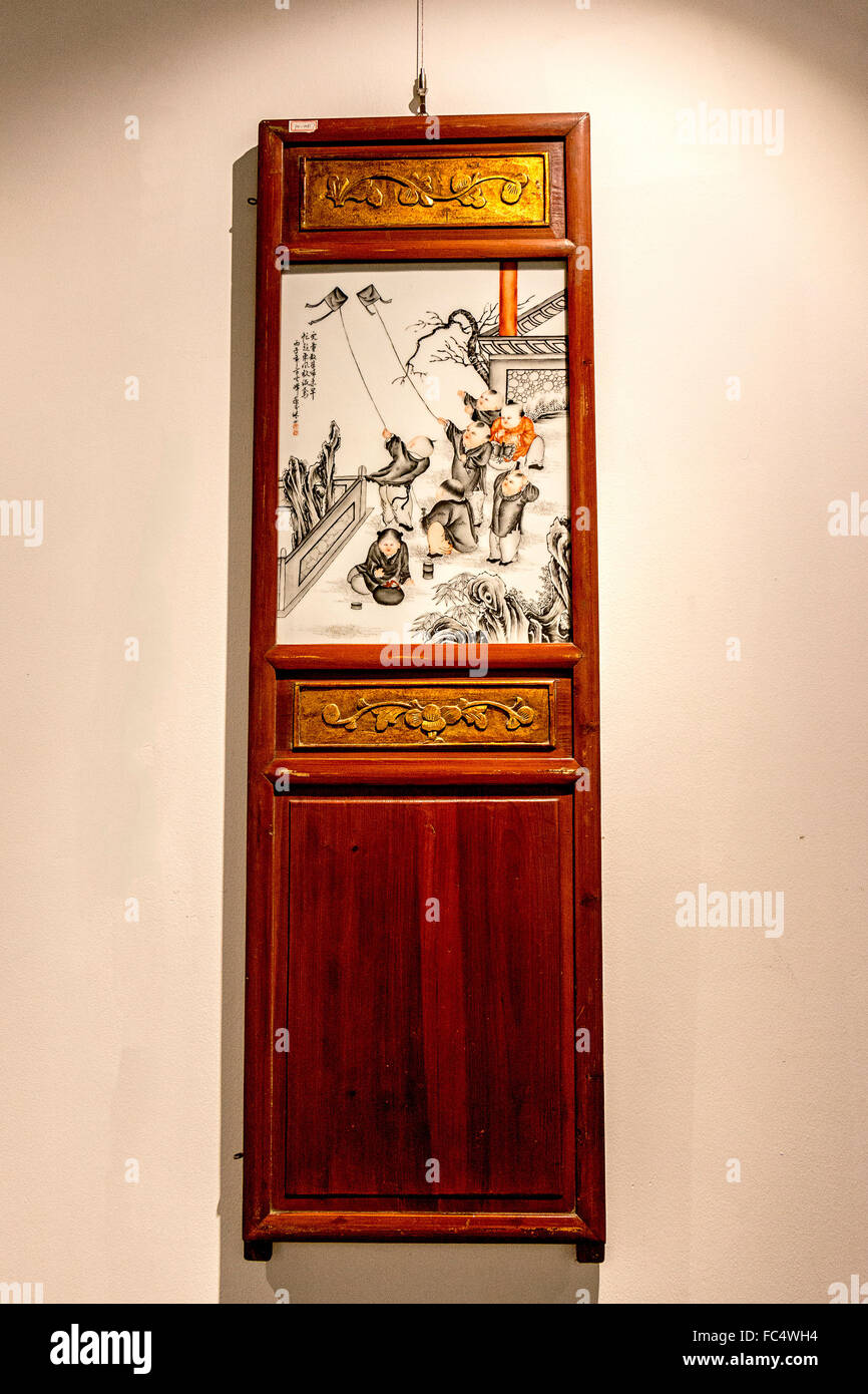 Scenes from ancient China in porcelain were part of furniture and doors 100 years ago. Stock Photo