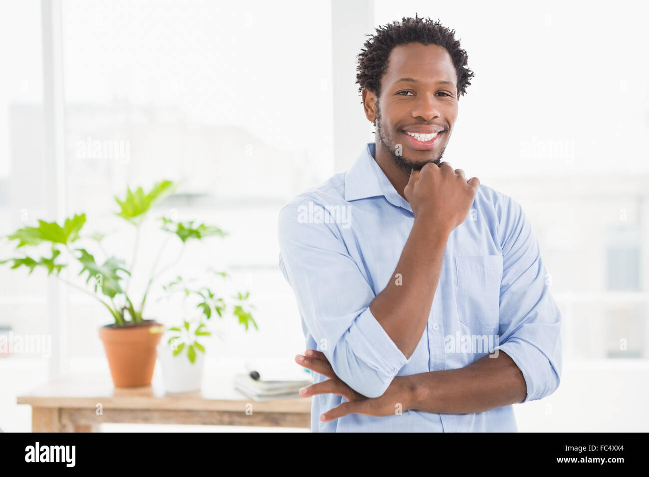 Young smiling businessman looking at the camera Stock Photo - Alamy