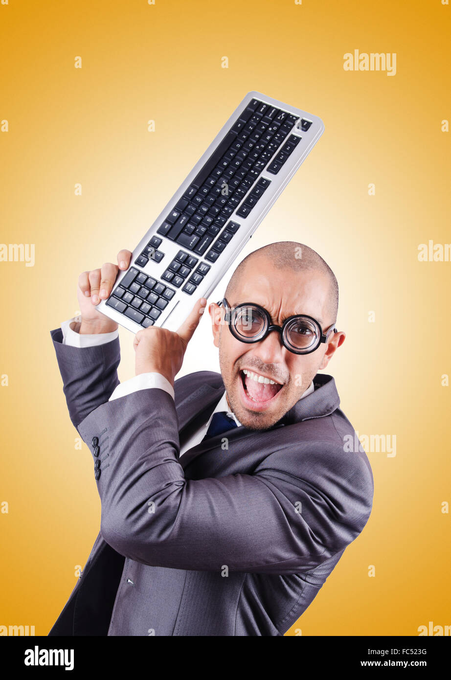 Nerd Using Keybords Nerd businessman with computer keyboard against gradient Stock Photo ...