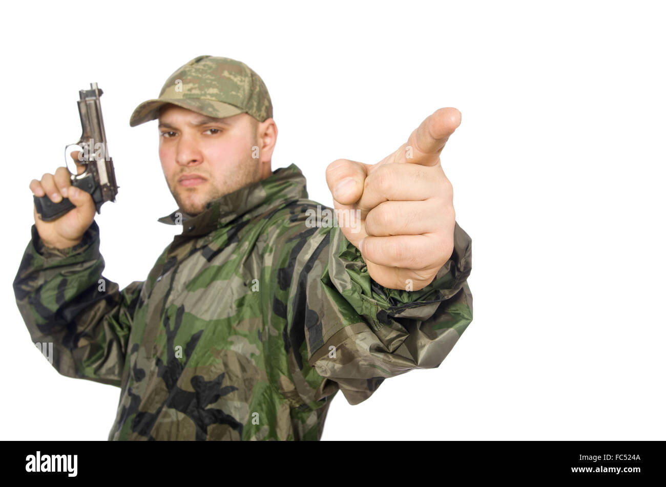 Young man in soldier uniform holding gun isolated on white Stock Photo