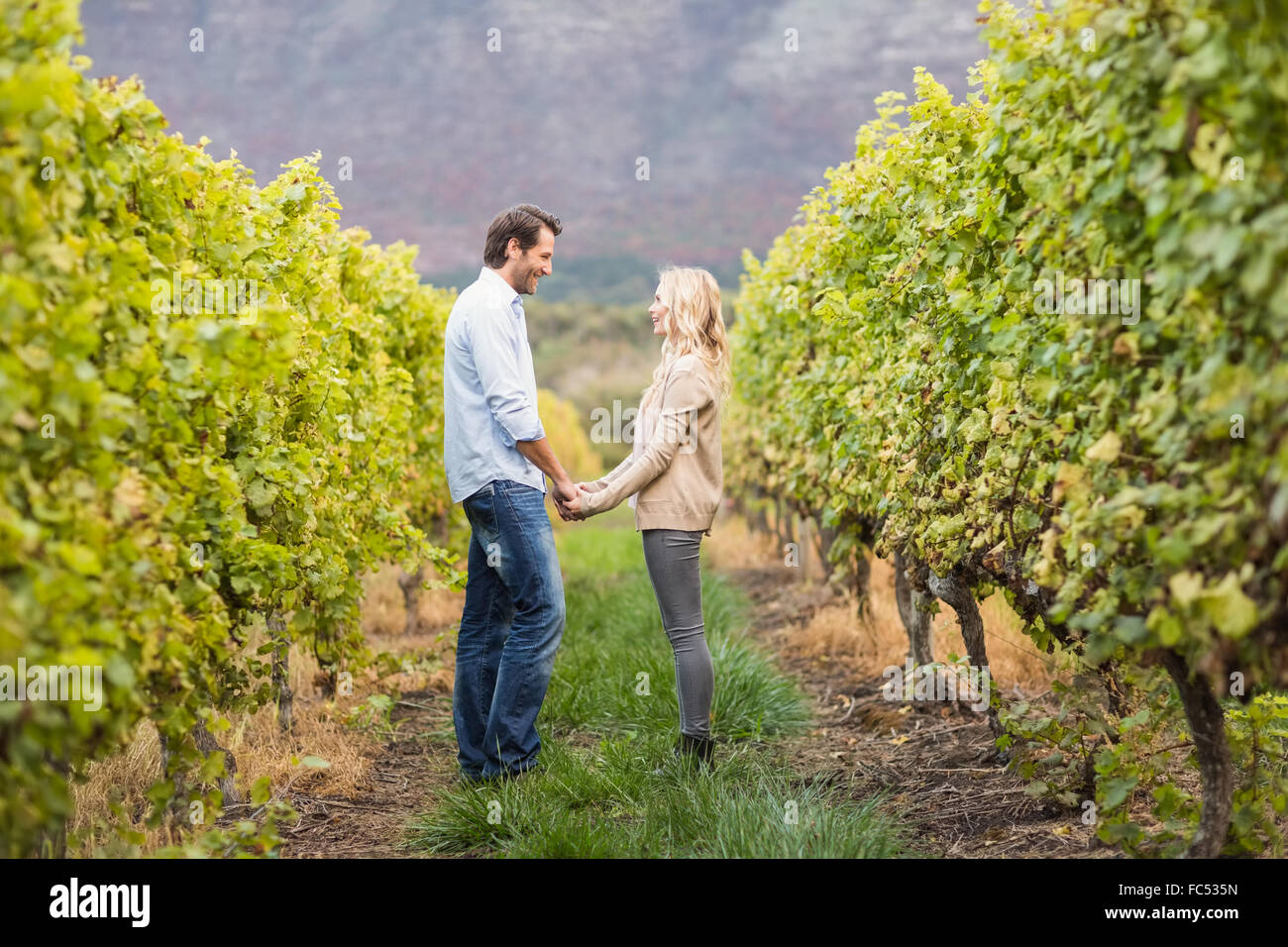 Young happy couple holding hands Stock Photo - Alamy