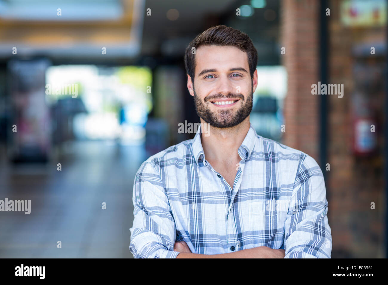 Portrait of man with arms crossed looking at camera Stock Photo - Alamy