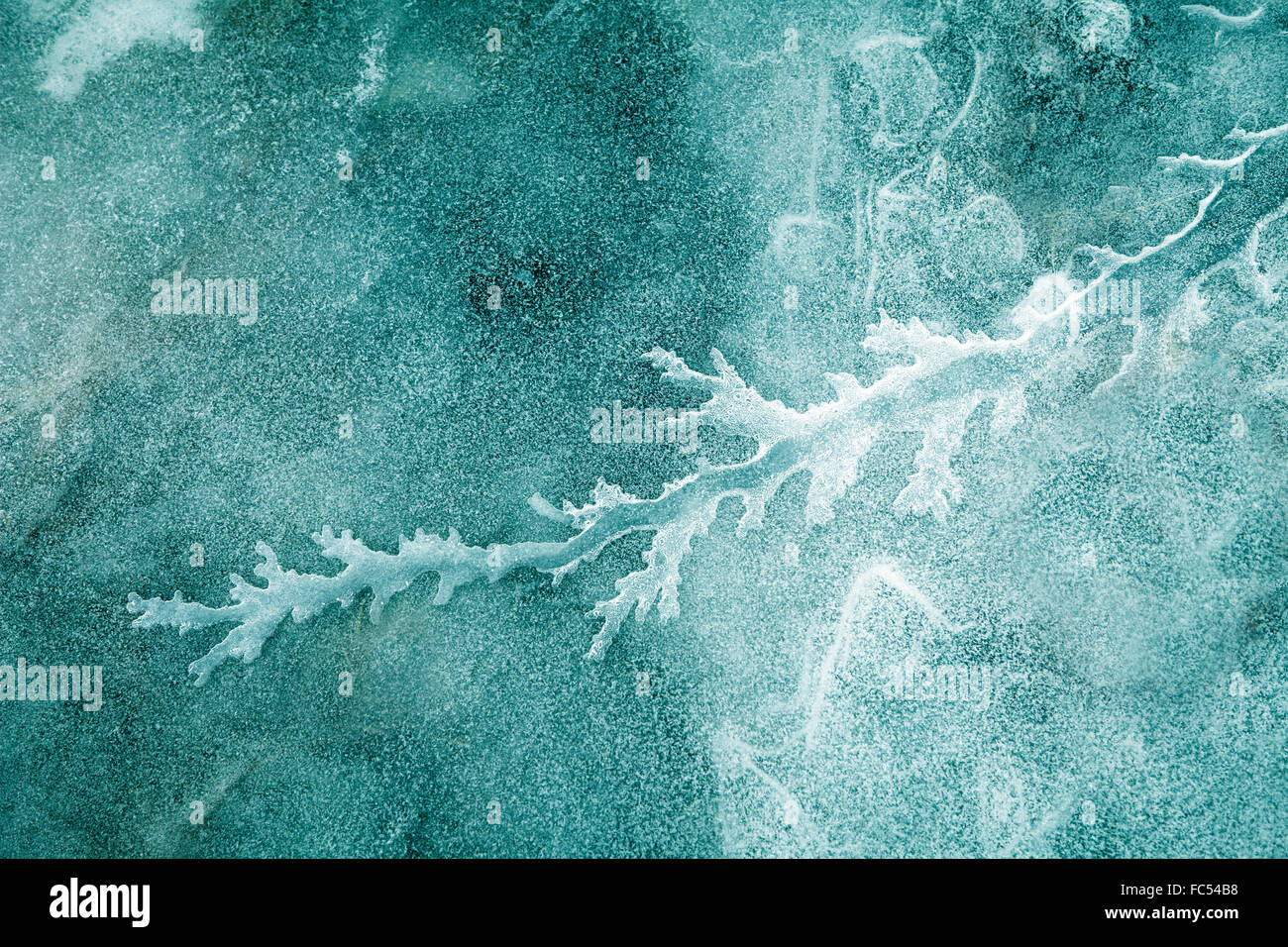 Flowing patterns of water flowing in ice in an Alaskan river. Stock Photo