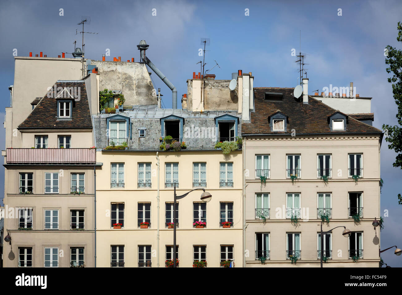 Row of typical Parisian buildings and rooftops along the River Seine in the Sorbonne neighborhood. Rue du Petit Pont, Left Bank. Stock Photo