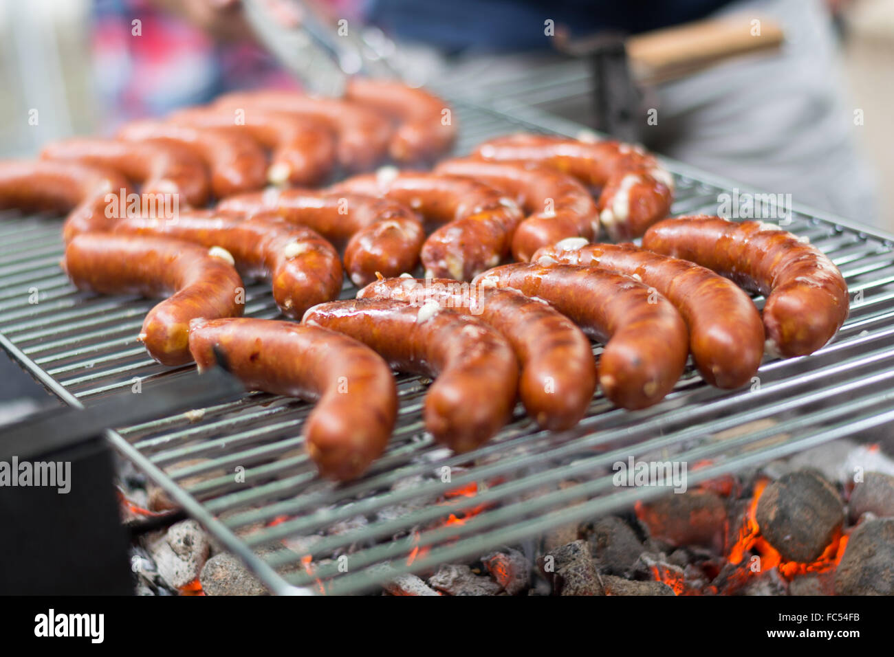 Sausages are grilled on charcoal grill Stock Photo