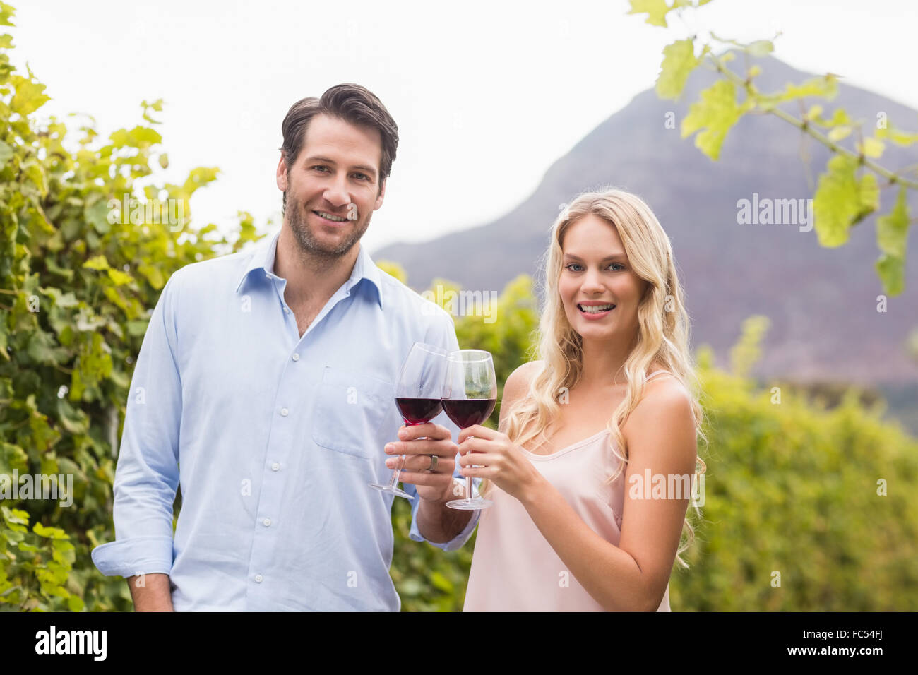 Young happy couple smiling at camera Stock Photo - Alamy