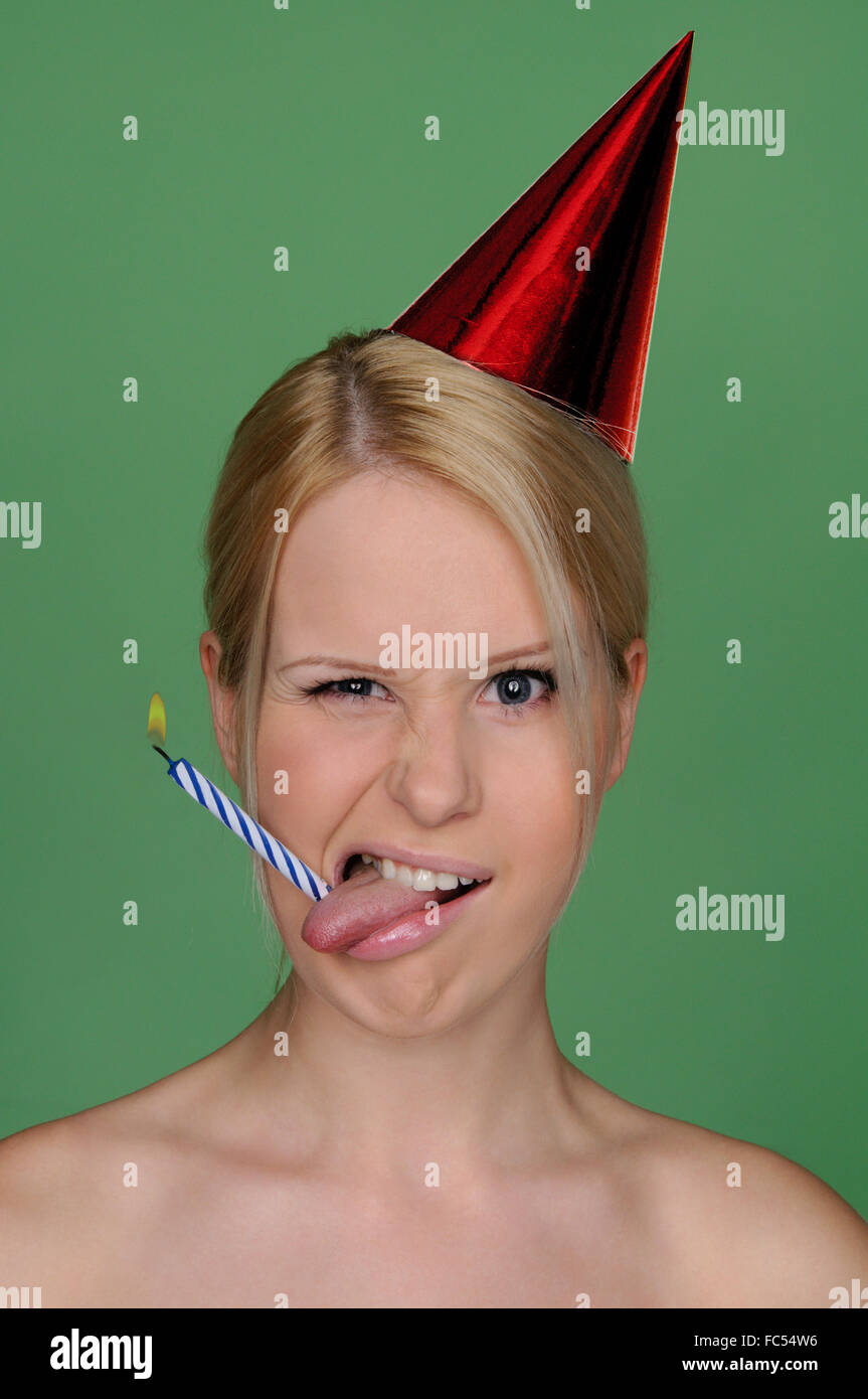 woman with candle in tongue and festive cap Stock Photo