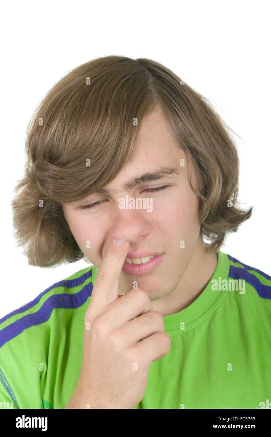 Teenager digs in a nose Stock Photo