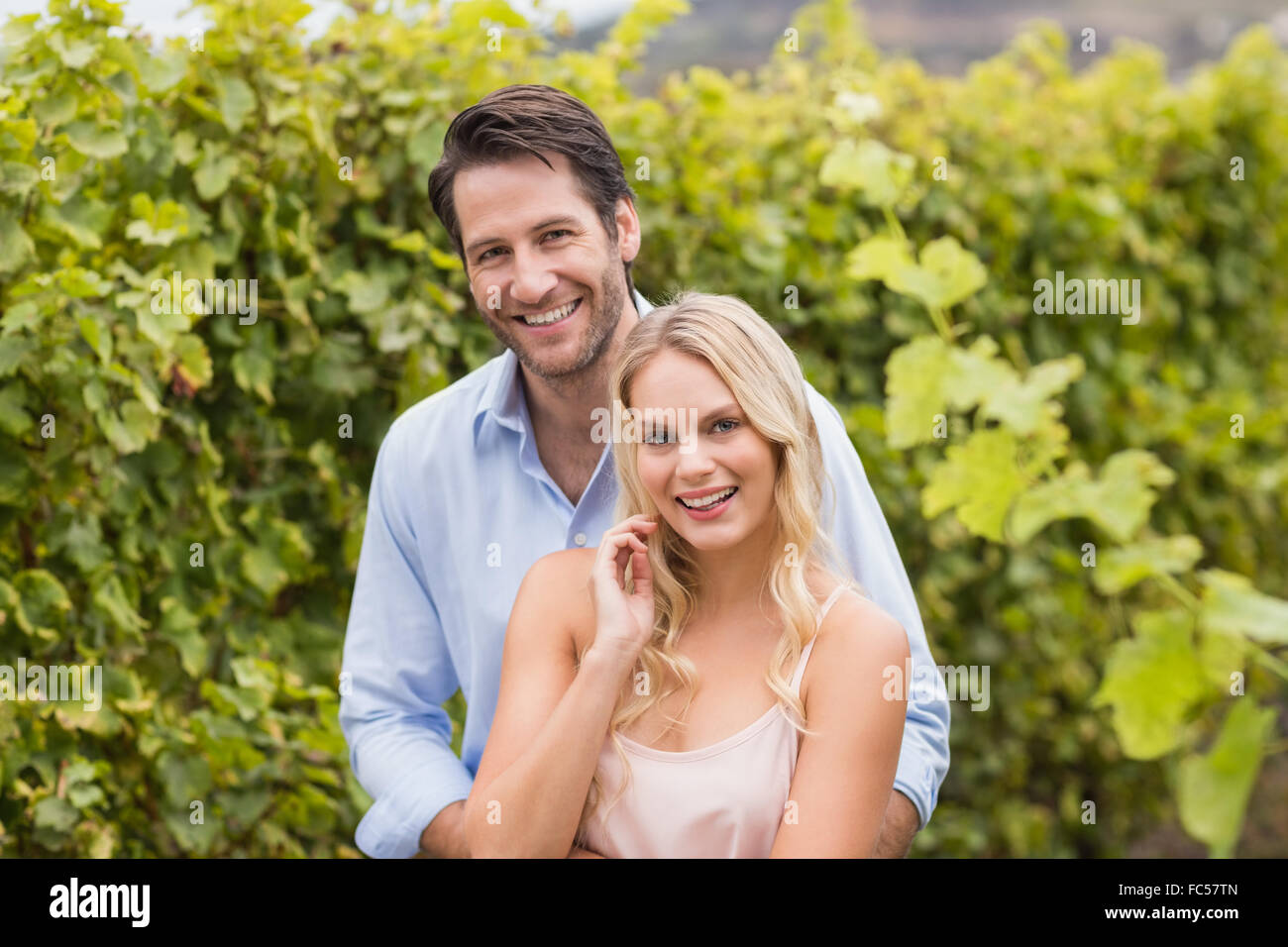 Young happy couple smiling at camera Stock Photo - Alamy