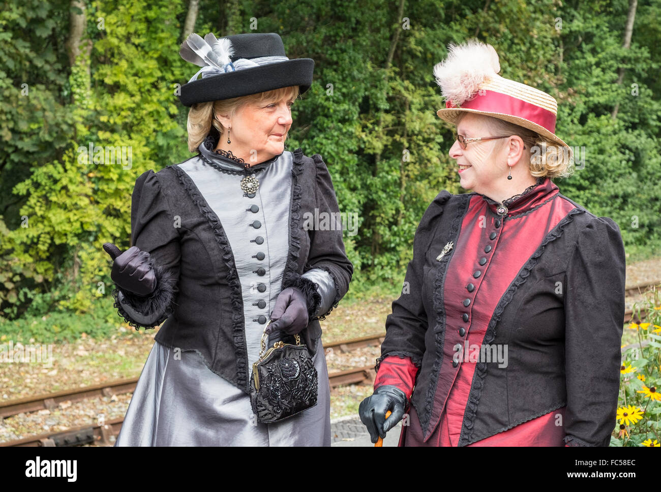 Two women in Victorian dress at the Bodmin & Wenford steam railway Victorian day in Cornwall, UK Stock Photo