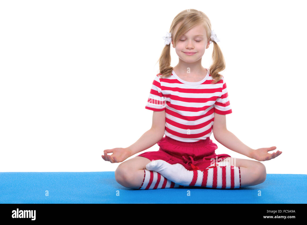 girl with eyes closed practicing yoga Stock Photo