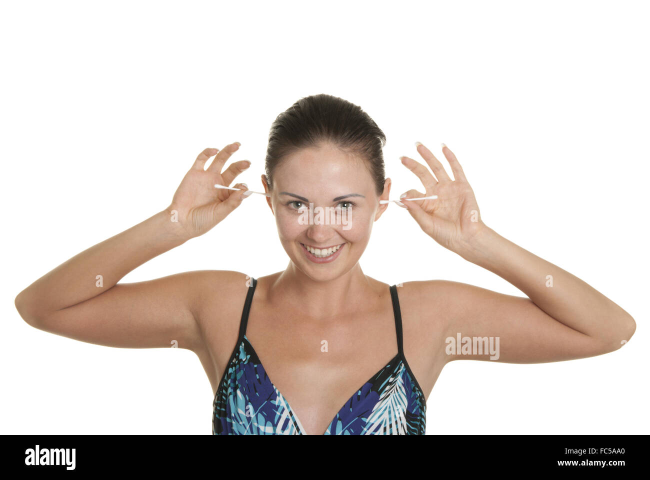 Smiling woman cleans ears two cotton buds Stock Photo