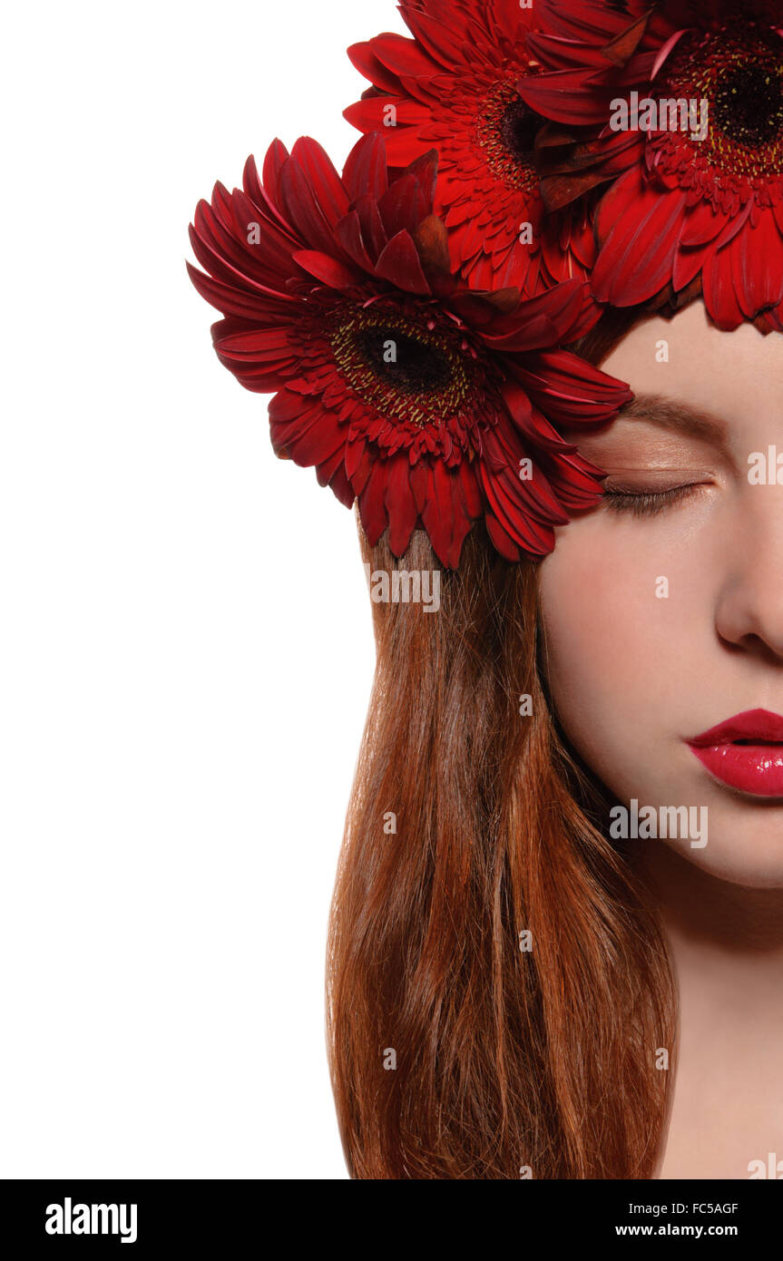 half of face girl with flowers in her hair Stock Photo