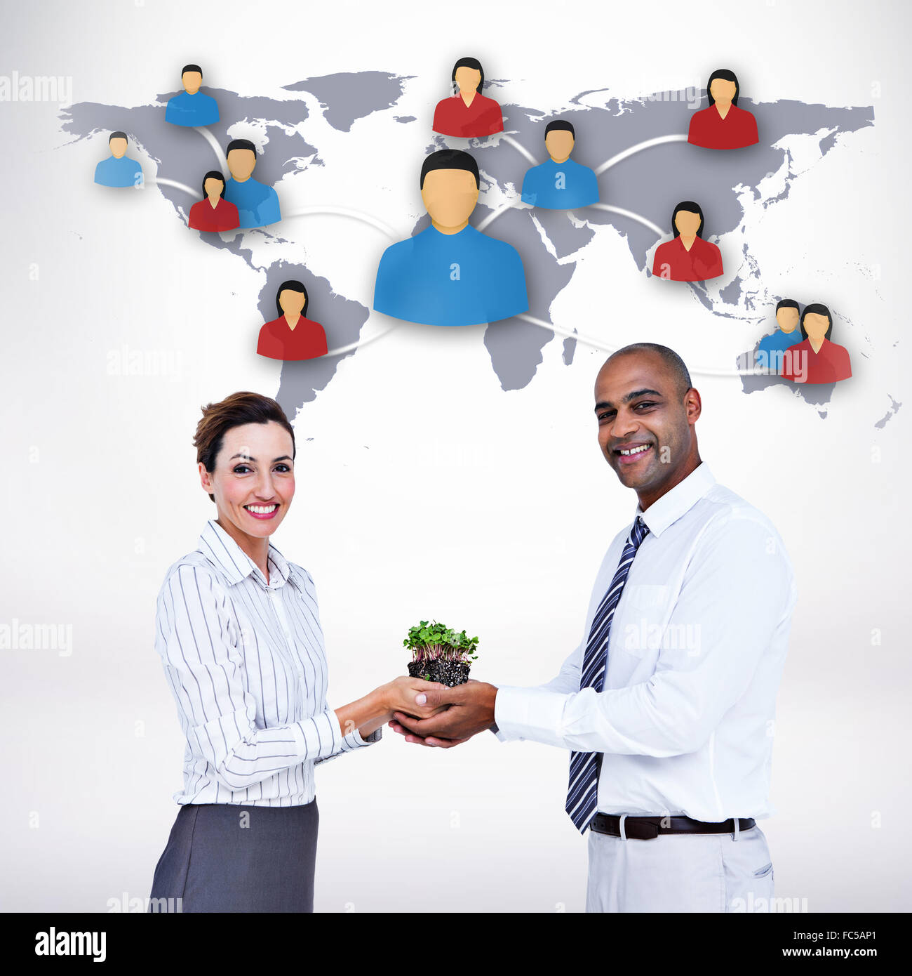 Composite image of business colleagues holding plant and looking at camera Stock Photo
