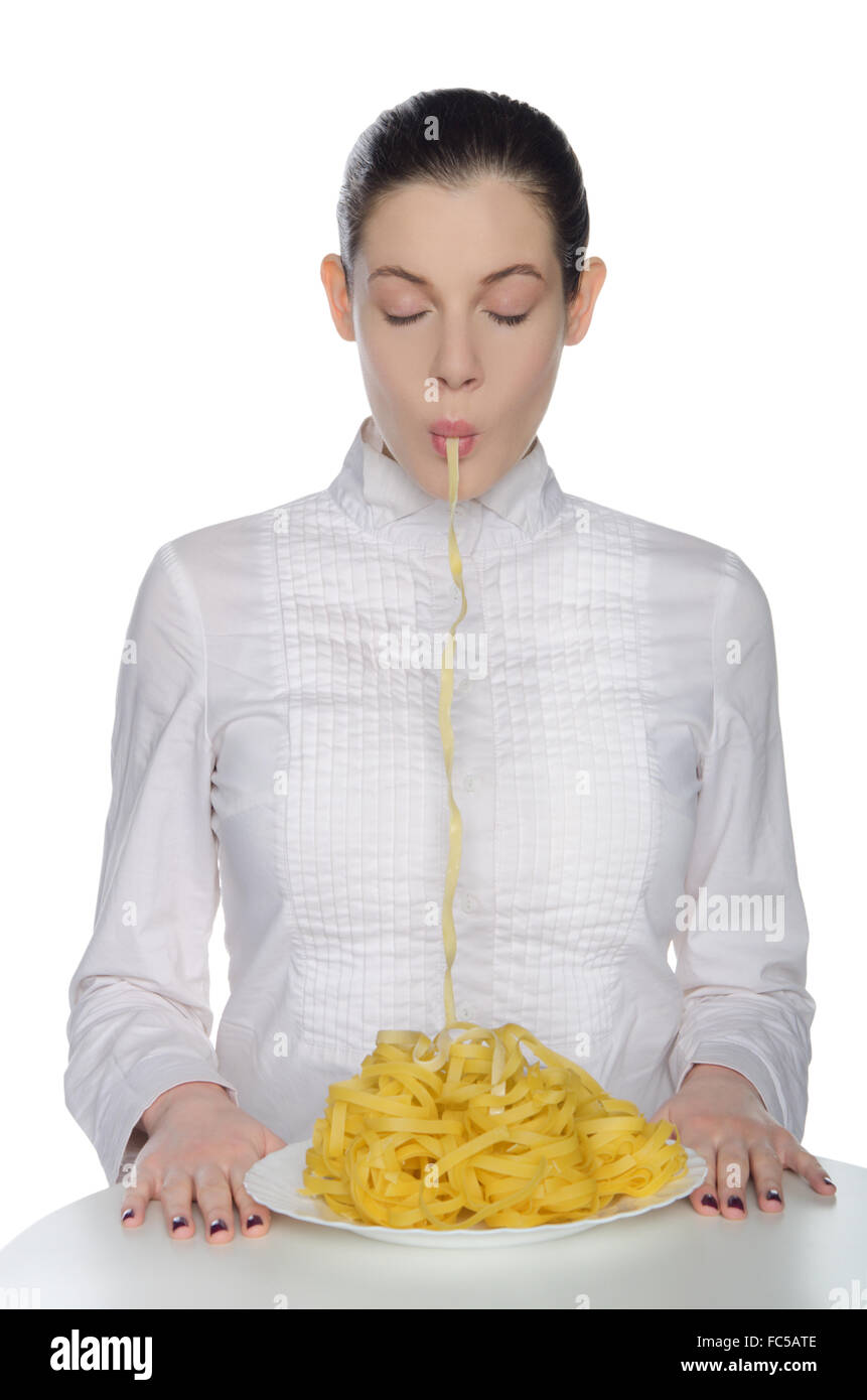 Woman with closed eyes eating pasta Stock Photo