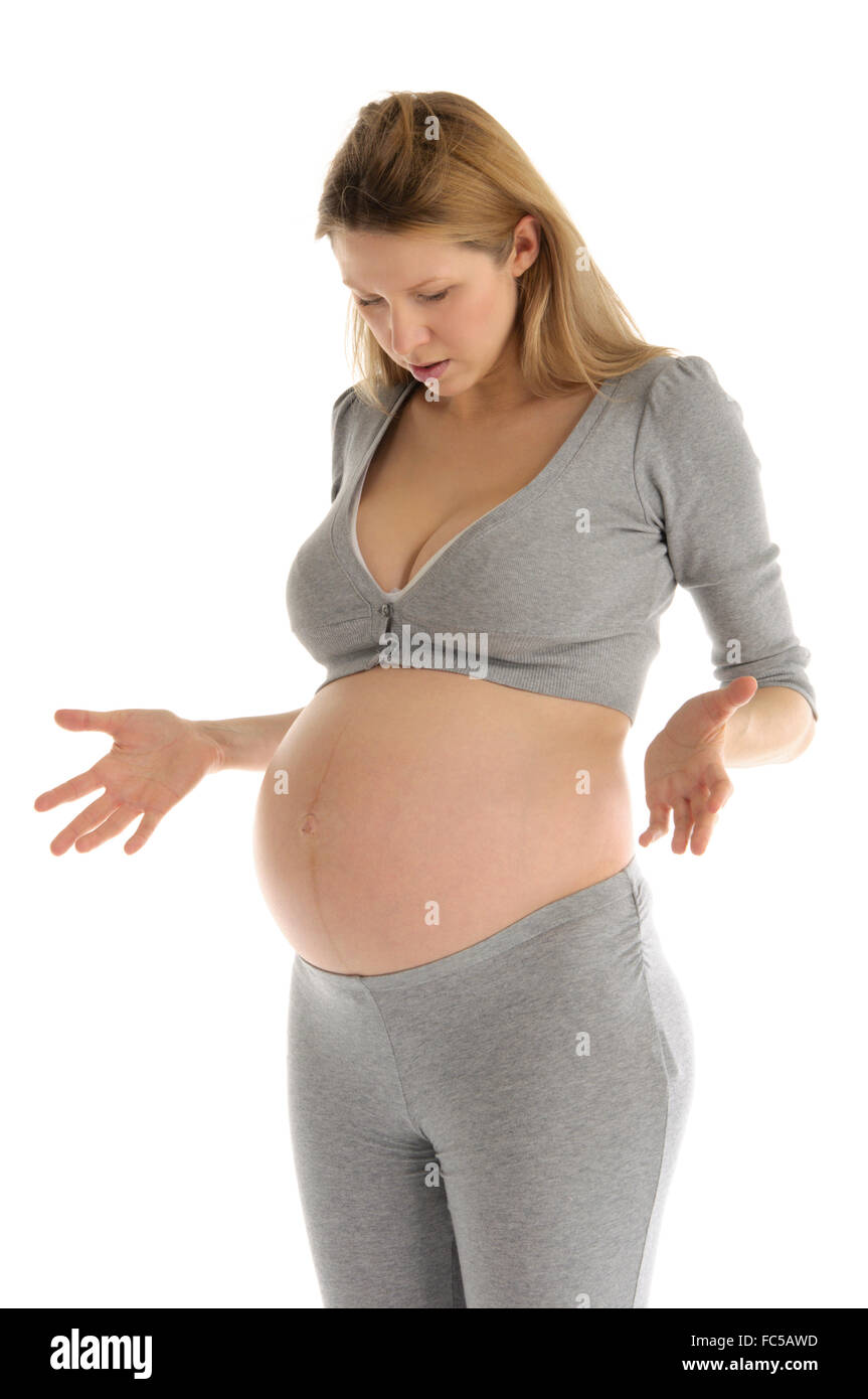 astonished pregnant woman in gray suit Stock Photo