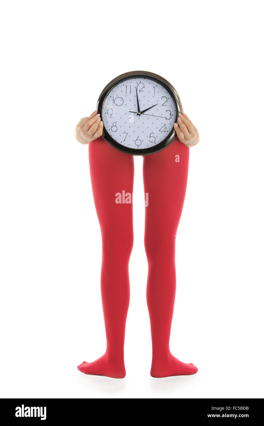Legs in red tights and clock Stock Photo