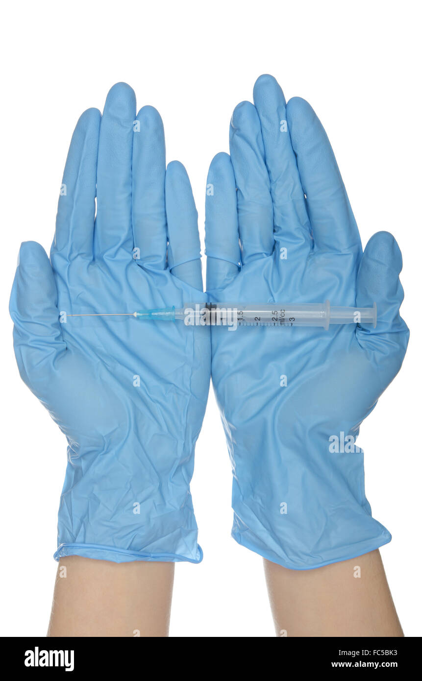 Syringe with on palms in gloves of nurses Stock Photo