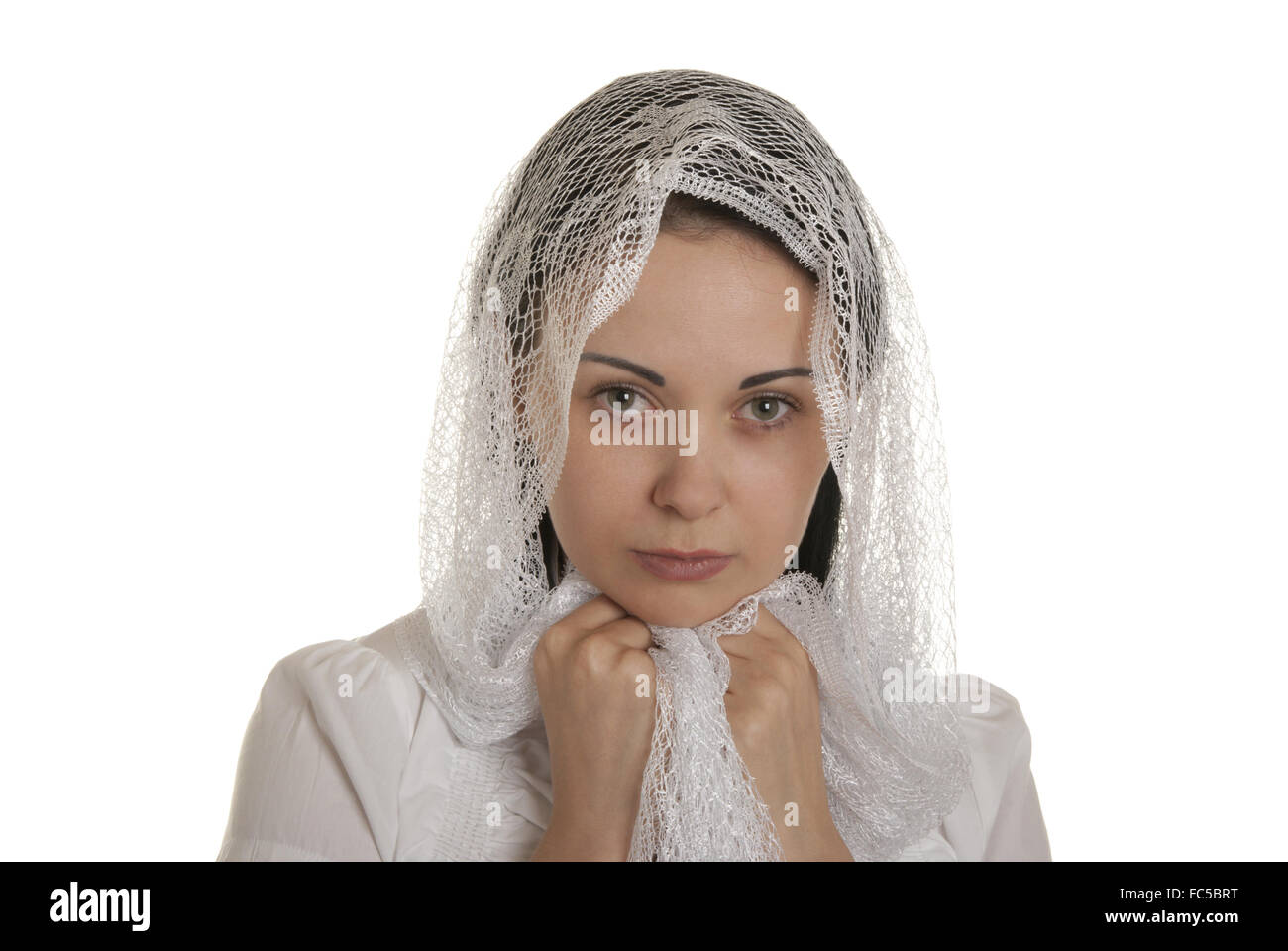 Defenceless woman with head scarf Stock Photo
