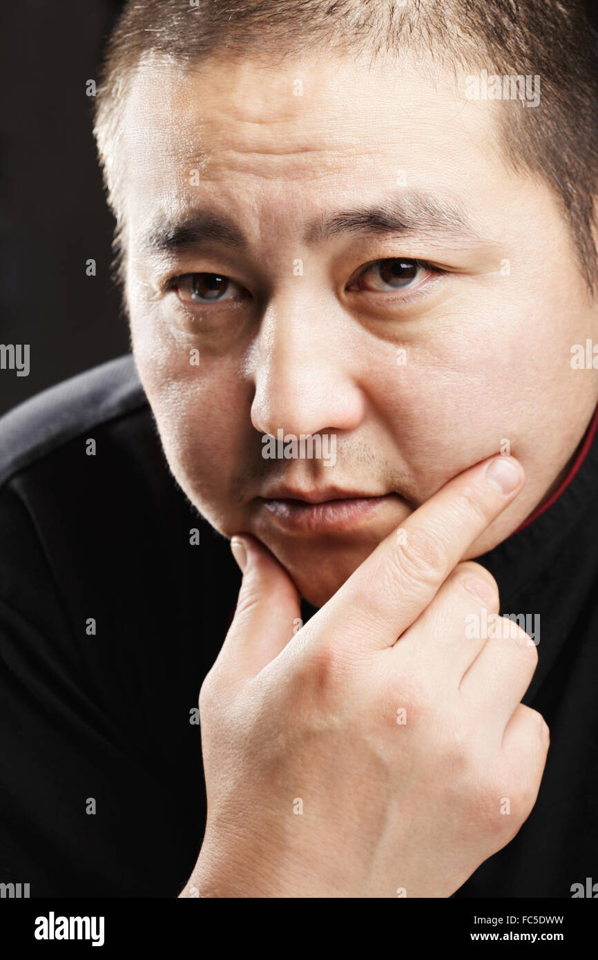 Middle-aged guy in black robe Stock Photo