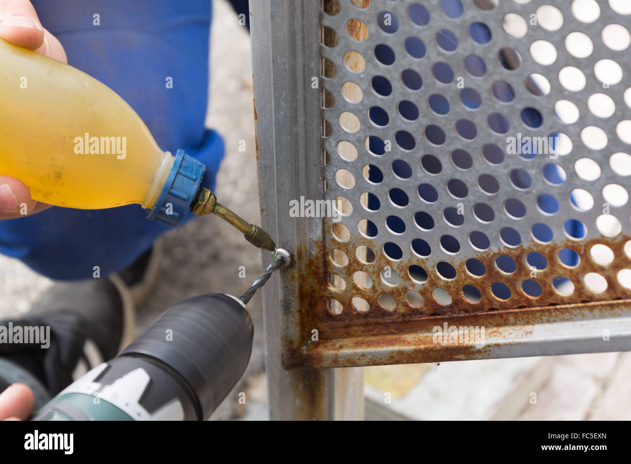 Skilled workers pierced with metal drill Stock Photo