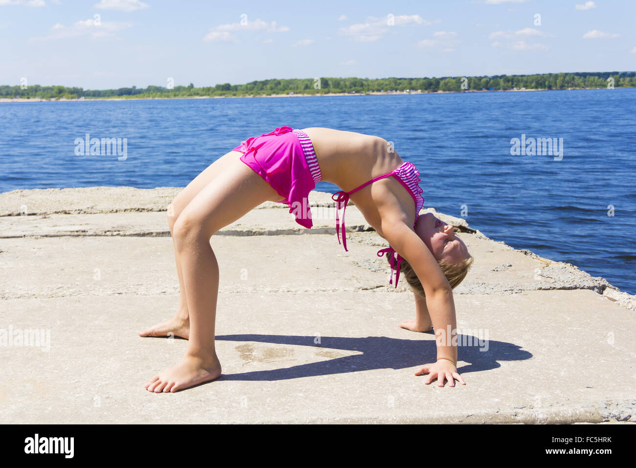 Girl practices yoga Stock Photo