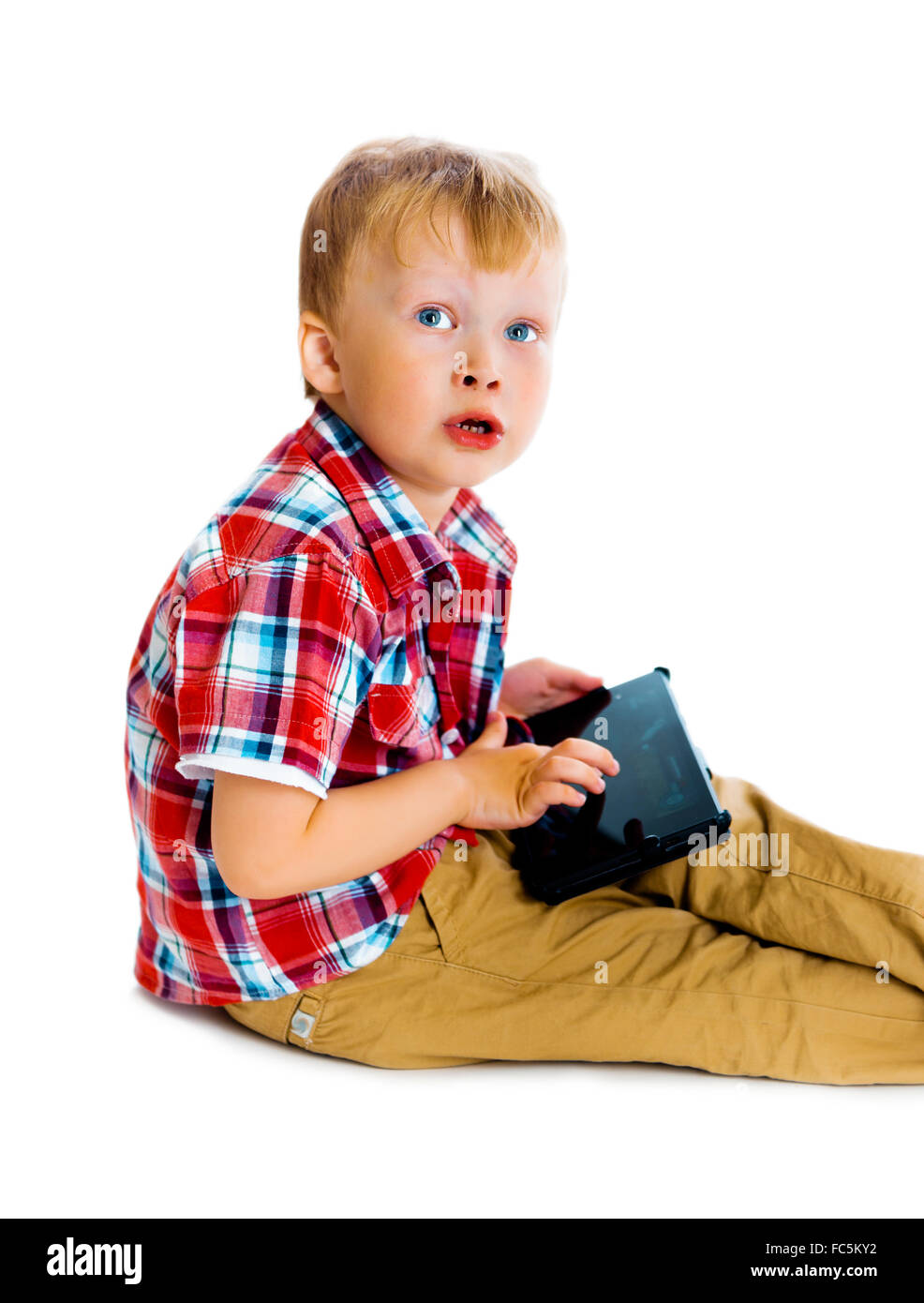 boy with a Tablet PC sitting on the floor Stock Photo - Alamy