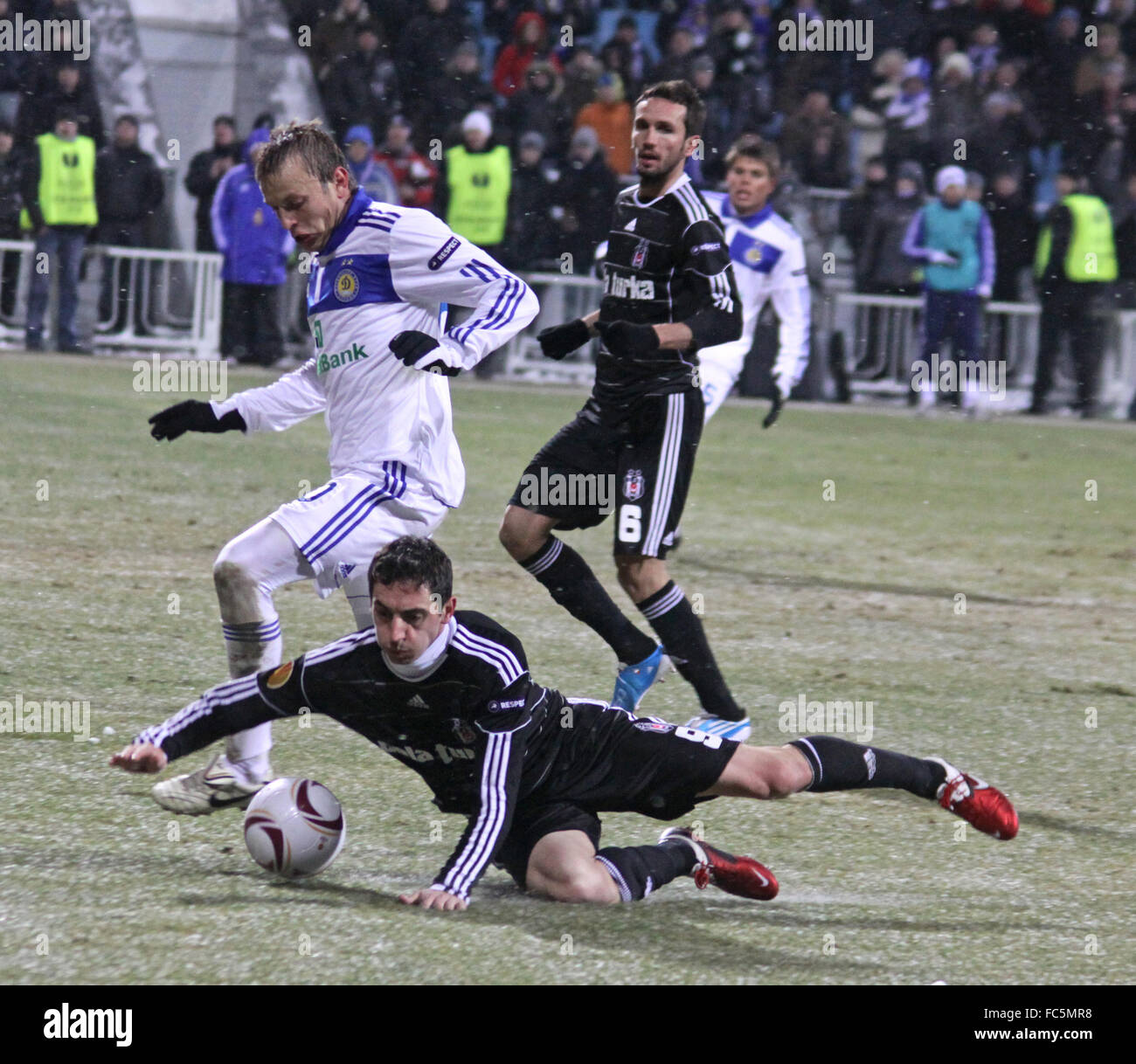 KYIV, UKRAINE - FEBRUARY 24: Oleg Gusev of Dynamo Kyiv (white) fights for a ball with Roberto Hilbert of Besiktas during their U Stock Photo