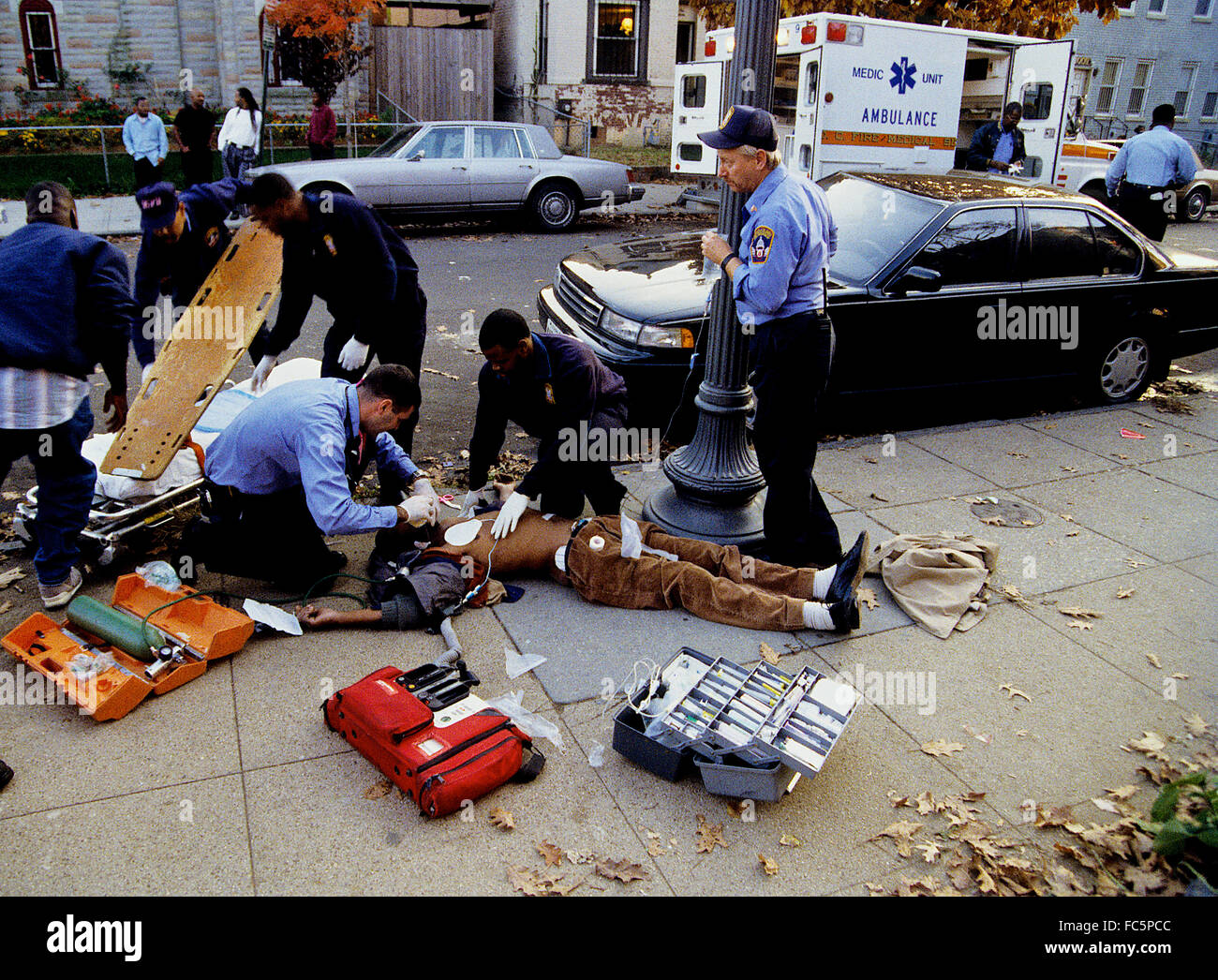 Washington, DC., USA, 1993 DC. Paramedics work on a shooting victim. Credit Mark Reinstein