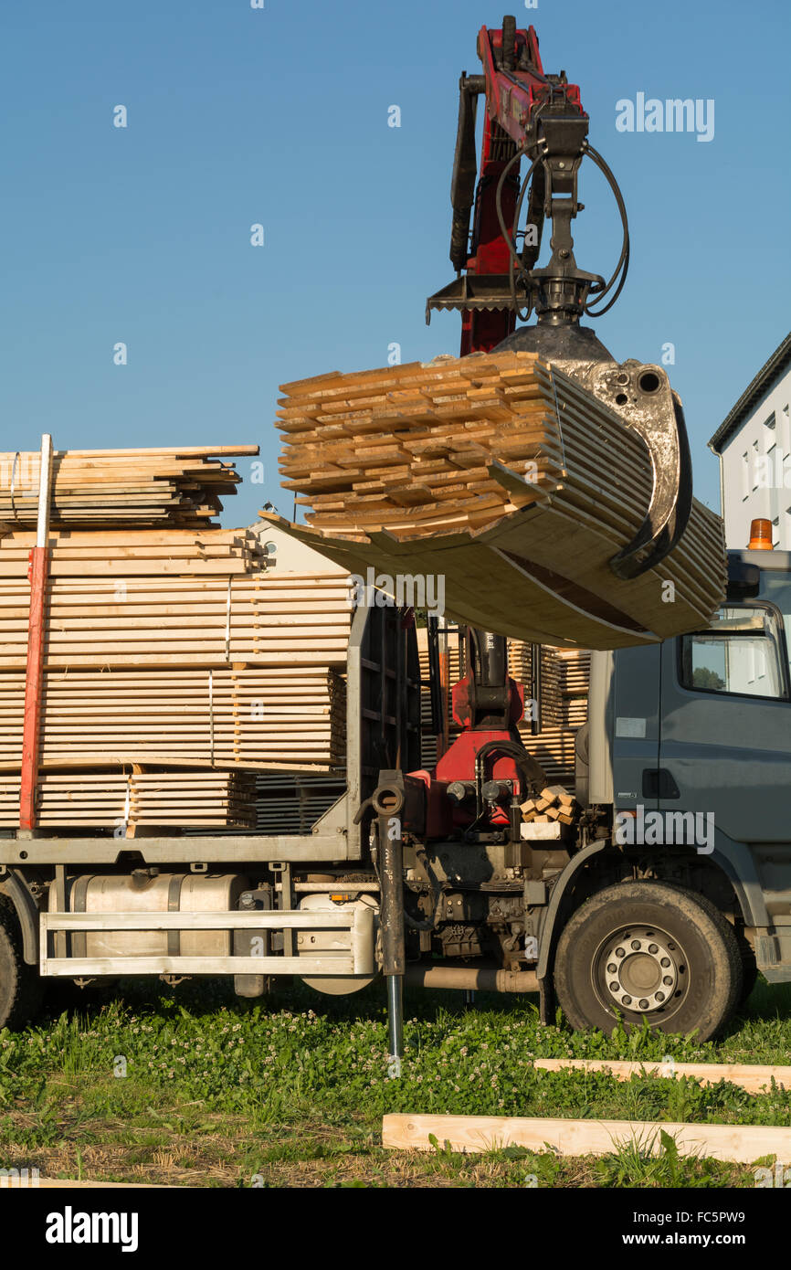 Truck crane lifts Timber Transporter Stock Photo
