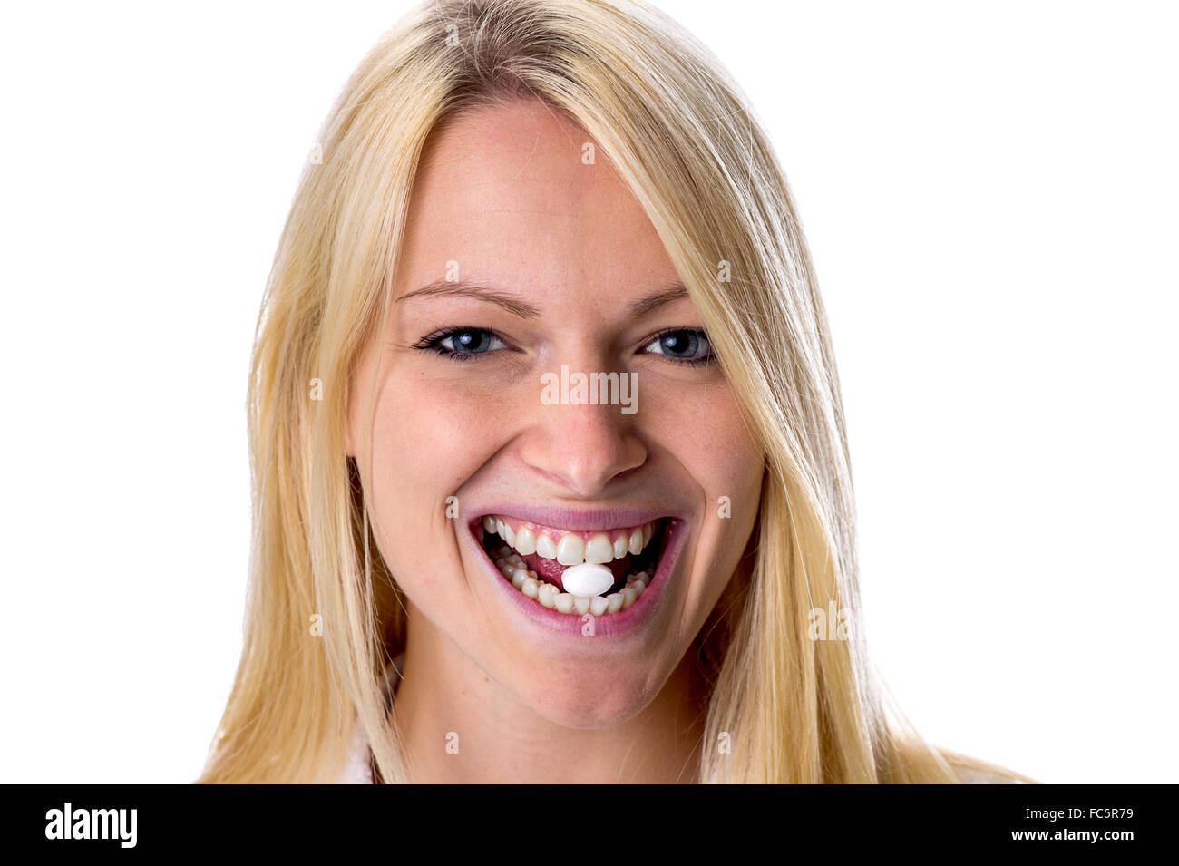 Blonde taking a pill to be Stock Photo