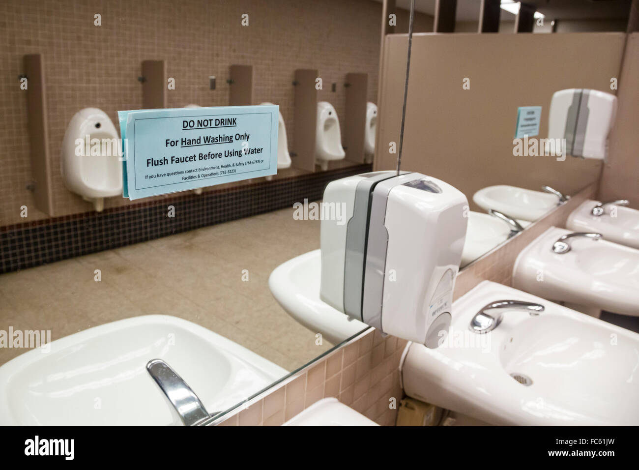 Flint, Michigan - A sign on the mirror in a men's restroom at the University of Michigan-Flint warns against drinking the water. Stock Photo
