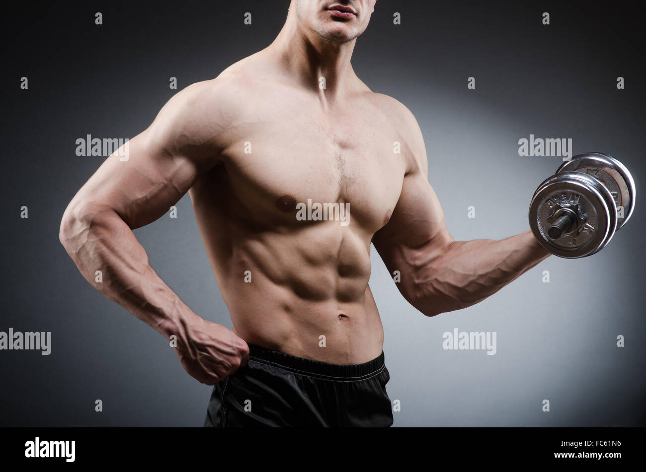 Muscular ripped bodybuilder with dumbbells Stock Photo - Alamy